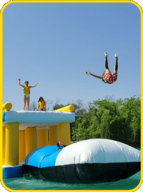 a kid launching into the air at sheboygan quarry beach's aqua park in sheboygan, wisconsin